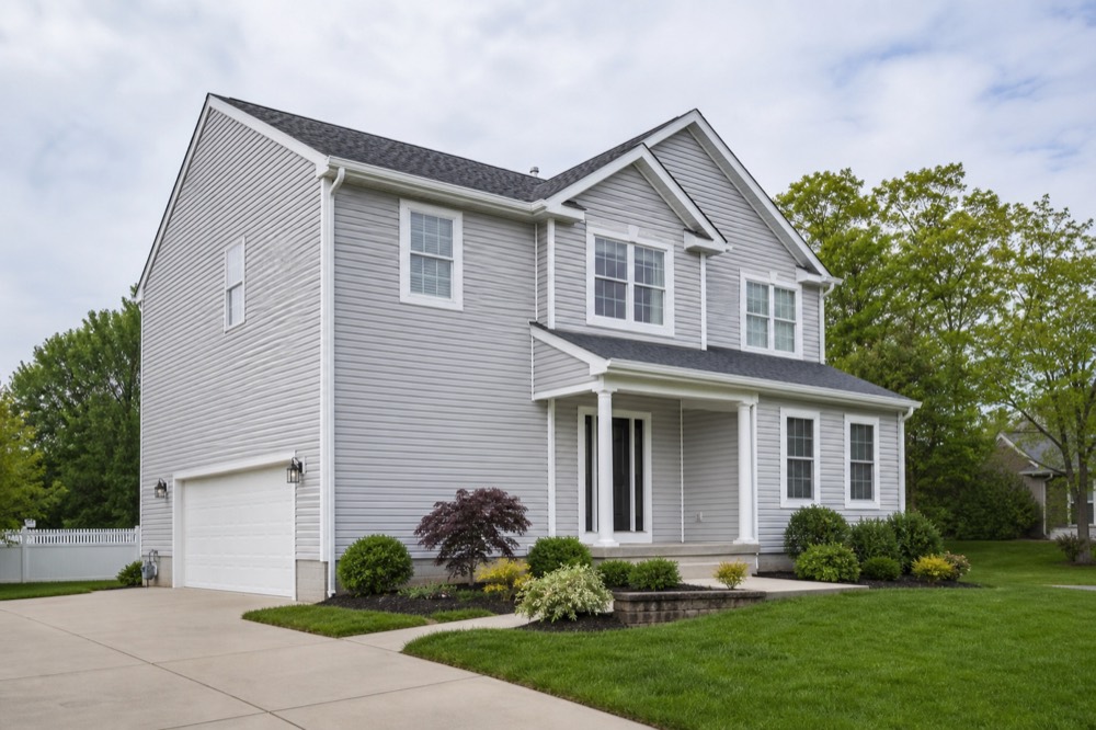 Completed light gray vinyl siding installation on a South Jersey home